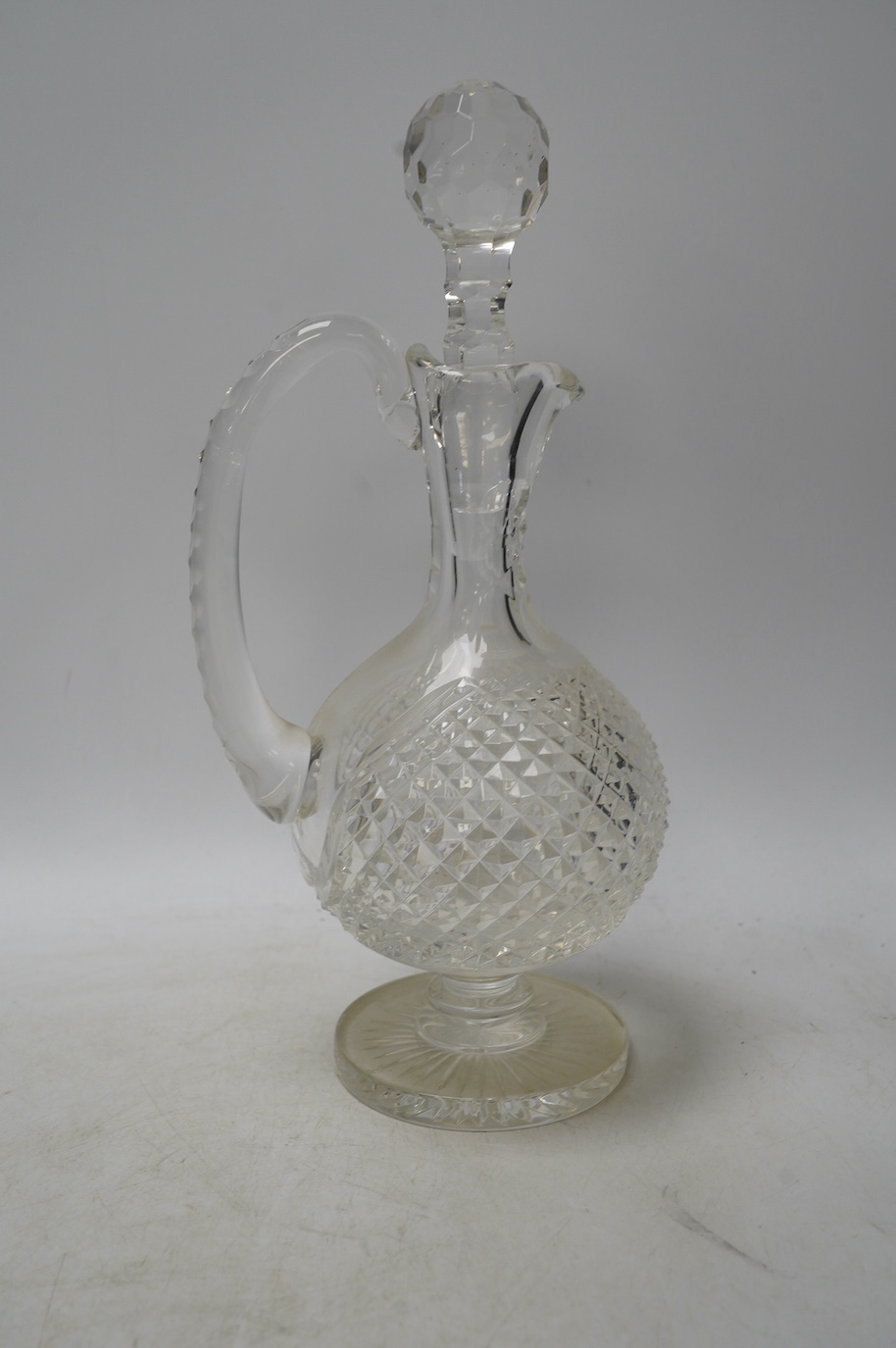 A brass mounted two bottle tantalus and three glass decanters / jugs, largest 32cm high. Condition - fair